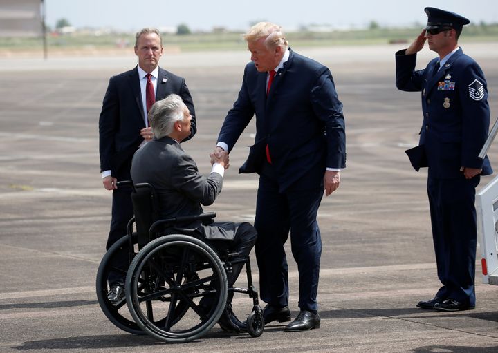 Gov. Greg Abbott, seen here greeting President Donald Trump in May 2018, appears to share Trump's concerns about refugees.