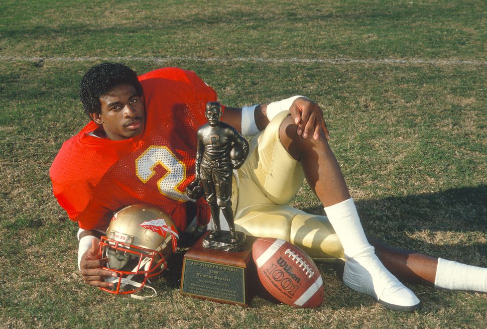 Defensive back Deion Sanders of the Florida State Seminoles poses with his 1988 Jim Thorpe Award trophy in Tallahassee.