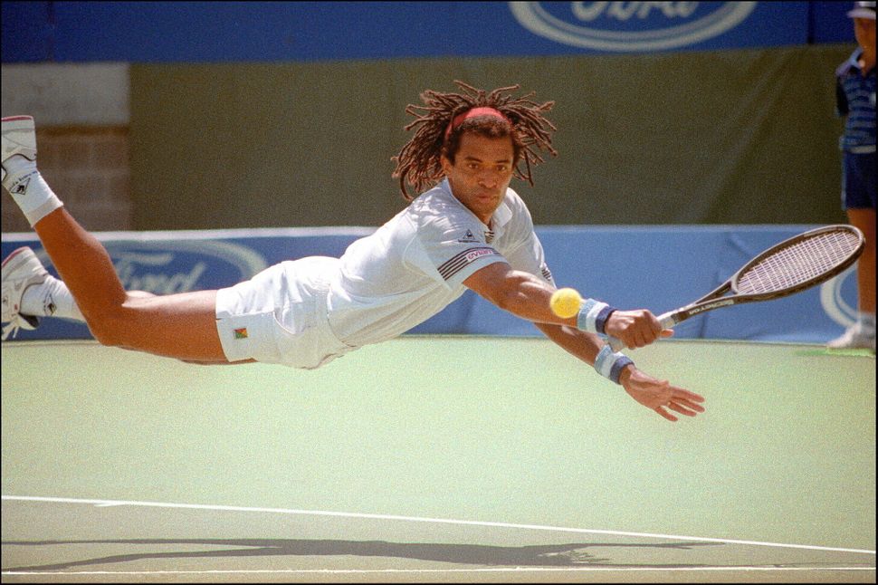 Yannick Noah dives for a return during his Australian Open match against Gilad Bloom of Israel on Jan. 19, 1990.