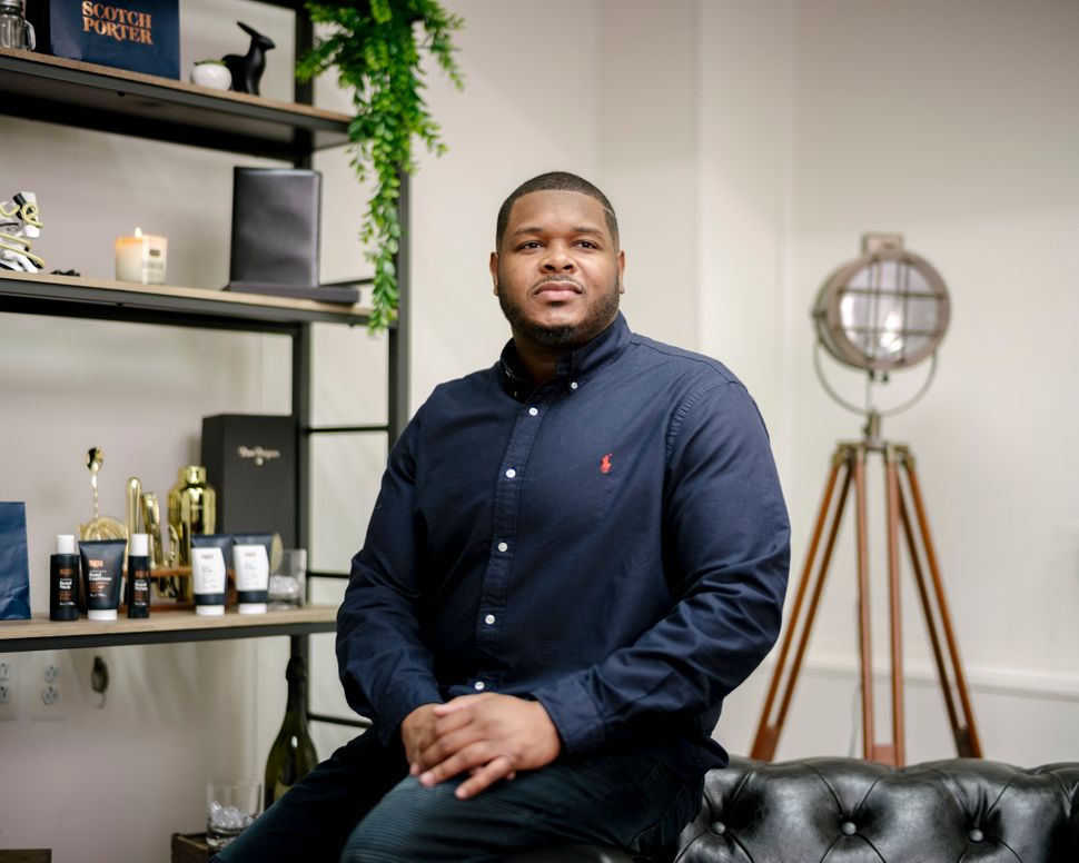 Calvin Quallis, founder of Scotch Porter, poses for a portrait at his warehouse and office space. Scotch Porter is a men's grooming business with a line of products for hair, beards, shaving and skin.