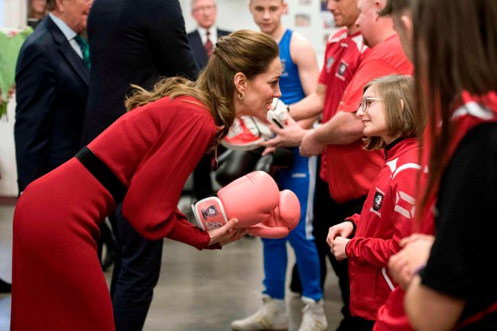 The duchess chats with a girl during a visit to a boxing club in Port Talbot. Check out those pink gloves!