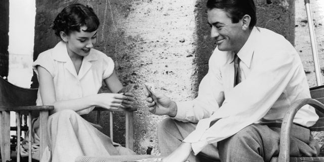 Audrey Hepburn plays cards with Gregory Peck in a scene from the film "Roman Holiday," 1953.