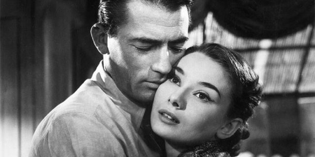 American actor Gregory Peck (1916 - 2003) and Belgian-born actress Audrey Hepburn (1929 - 1993) embrace in a still from director William Wyler's film, 'Roman Holiday'.