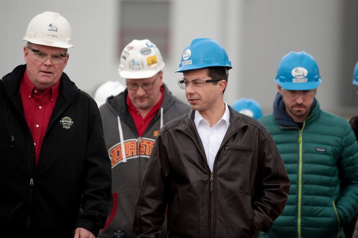 Pete Buttigieg, center, exits a tour of an ethanol plant in Mason City, Iowa, in early November. Courting rural voters was a 