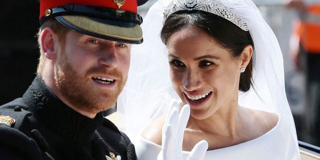 Meghan and Harry ride in an open-topped carriage after their wedding ceremony at St. George's Chapel in Windsor Castle in Windsor, near London, England.