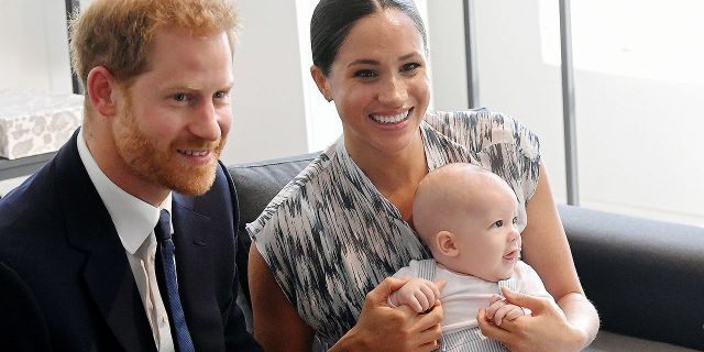 Meghan and Harry pose with their baby Archie.