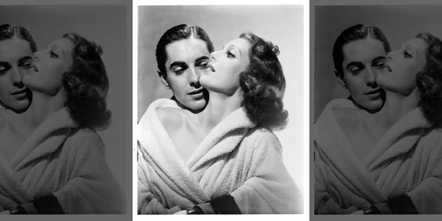 Tyrone Power holds Loretta Young in publicity portrait for the film 'Love Is News', 1937.