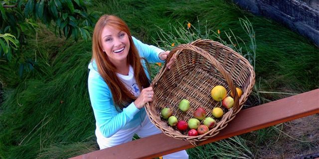 Actress and artist Jane Seymour stands on the deck of her home overlooking the Pacific ocean with items picked from her garden on June 12, 2002. in Malibu, California.