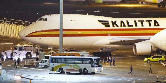 A bus carrying U.S. passengers who were aboard the quarantined cruise ship the Diamond Princess arriving at Haneda Airport in Tokyo. (Sadayuki Goto/Kyodo News via AP)