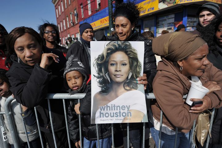 People gather outside New Hope Baptist Church during a private funeral for singer Whitney Houston on Feb. 18, 2012, in Newark