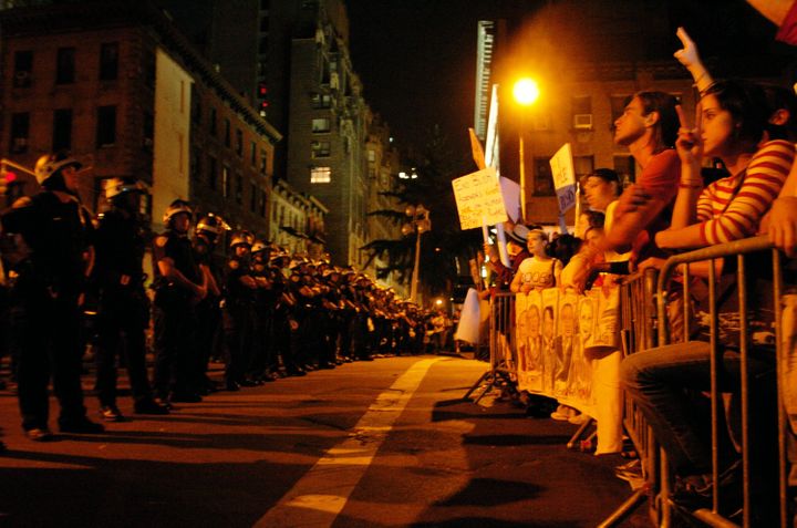 Police face protesters outside Madison Square Garden as then-President George W. Bush delivers his speech on the last day of 