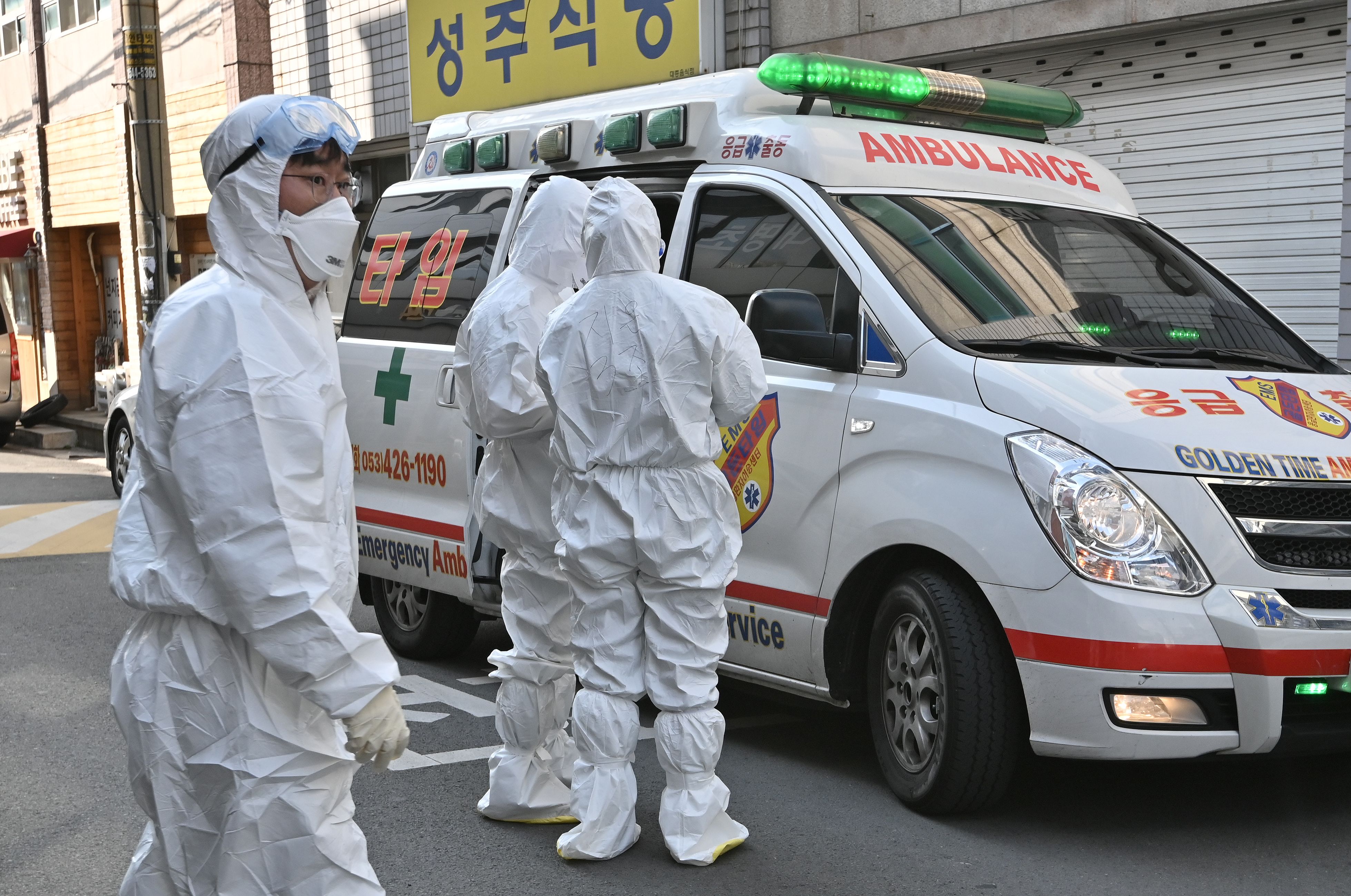 South Korean medical workers wearing protective gear visit a residence of people with suspected symptoms of the coronavirus in Daegu on Thursday.