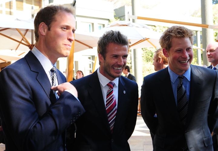 Prince William (left) and Prince Harry flank David Beckham at a reception in Johannesburg on&nbsp;June 19, 2010, in honor of 