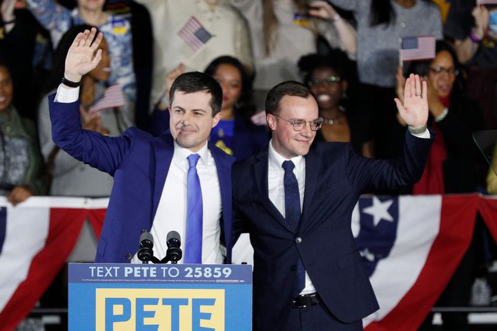 Democratic presidential candidate Pete Buttigieg, left, waves with his husband Chasten Buttigieg after declaring victory in I