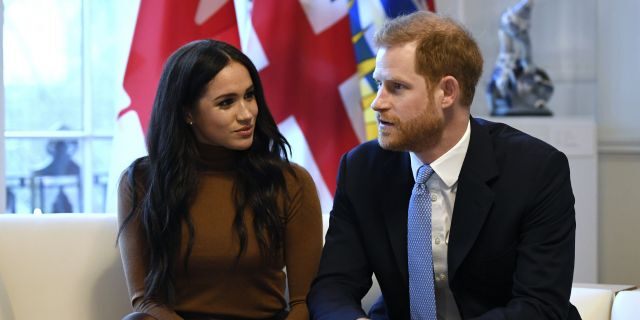 Britain's Prince Harry and Meghan, Duchess of Sussex gesture during their visit to Canada House in thanks for the warm Canadian hospitality and support they received during their recent stay in Canada, in London, Tuesday, Jan. 7.
