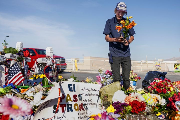 Antonio Basco, whose wife, Margie Reckard, was one of 22 killed by a gunman at a local Walmart, lays flowers in her honor at 