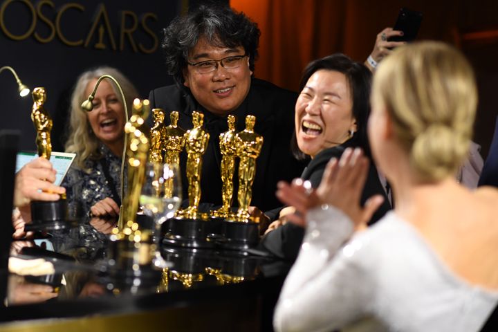 "Parasite" director Bong Joon Ho, producer Kwak Sin-ae and actor Renee Zellweger wait for their awards to be engraved.