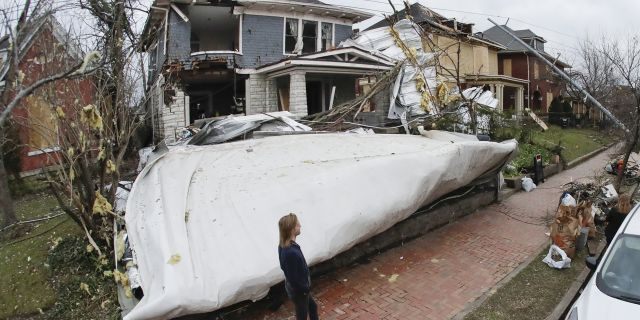 A roof from a nearby business lies in the front yard of a home Wednesday, March 4, 2020, in Nashville, Tenn. Residents and businesses faced a huge cleanup effort after tornadoes hit the state Tuesday, killing 24 people and leaving many others missing. 