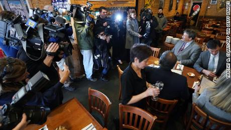 Westchester County Executive George Latimer, center, and New Rochelle Mayor Noam Bramson, right, are surrounded by the press as they eat lunch at Eden Wok Kosher Chinese in New Rochelle, New York, on March 5, 2020.