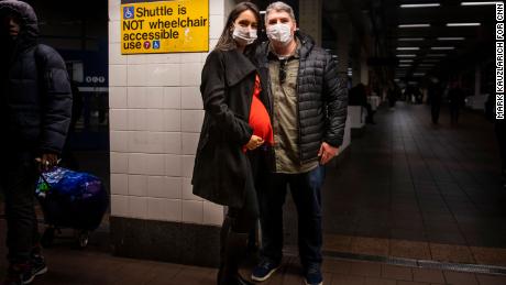 Leonardo Gayer and wife Vanessa, visiting from Brazil, wear surgical masks in the New York subway. 