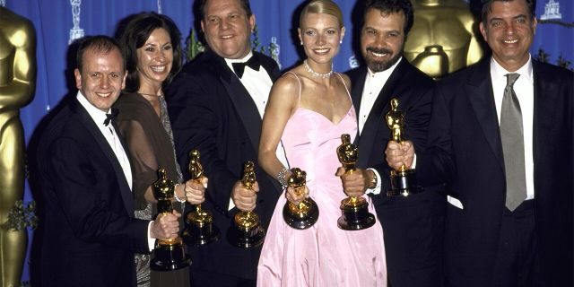 Miramax Films executive Harvey Weinstein (3rd L) and actress Gwyneth Paltrow (3R) w. producers of 'Shakespeare in Love' holding their Oscars in Press Room at Academy Awards.