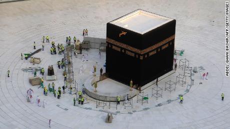 Workers clean the inside of Mecca&#39;s Grand Mosque on Thursday after Saudi Arabia emptied the holy site due to coronavirus fears. 