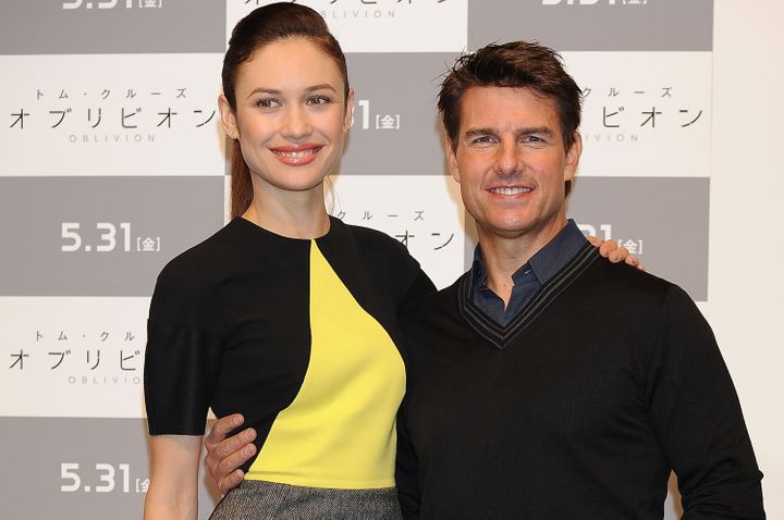 Kurylenko and Tom Cruise at an "Oblivion" press conference in Tokyo in 2013.