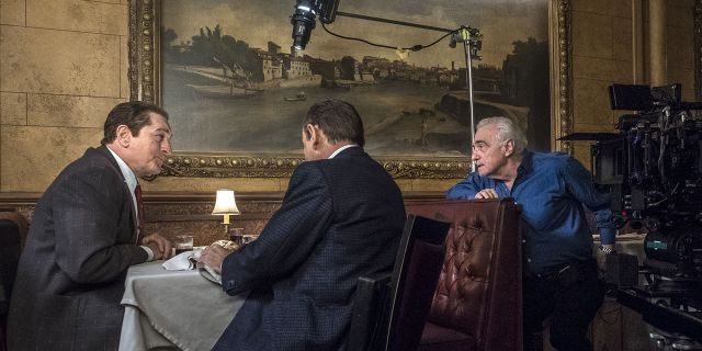 This image released by Netflix shows director Martin Scorsese, right, with actors Robert De Niro, left, and Joe Pesci on the set of "The Irishman." 