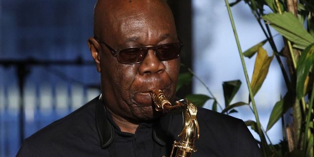 Saxophonist Manu Dibango performs during Franck Sorbier's Haute Couture Spring-Summer 2018 fashion collection in Paris. Renowned jazz man Manu Dibango, to many the beloved "Papy Groove" who served as an inspiration and pioneer in his art, died on Tuesday from the coronavirus, his official Facebook page announced. 