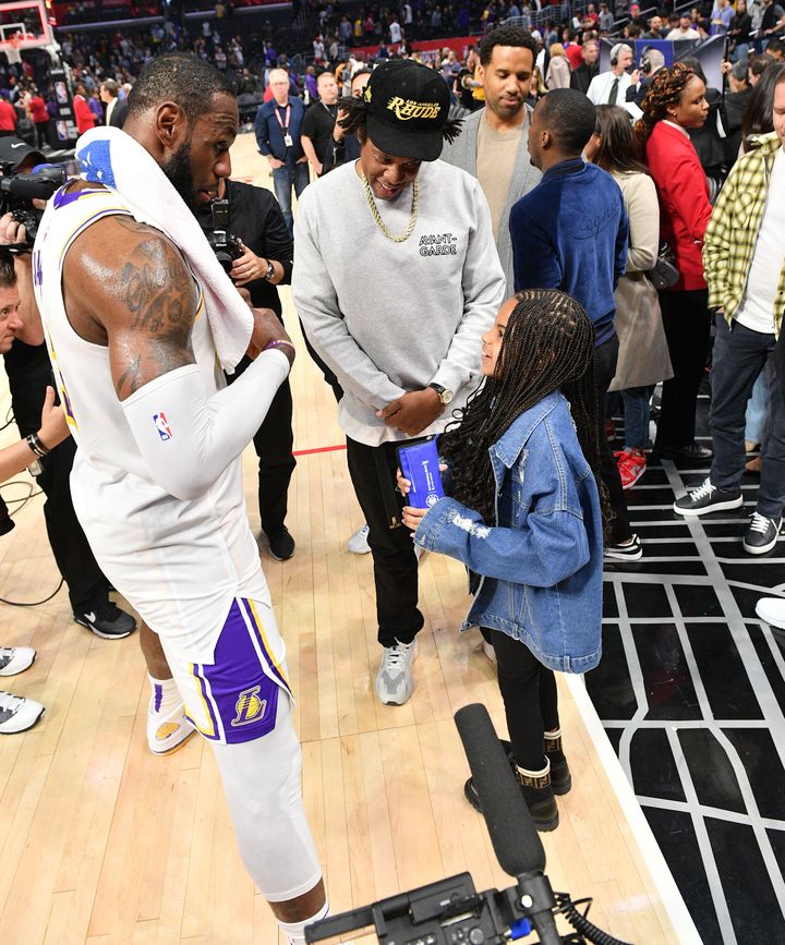 LeBron James and Blue Ivy have a chat as Jay-Z looks on.
