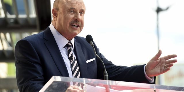 FILE - This Feb. 21, 2020 file photo shows talk show host Dr. Phil McGraw speaking during a ceremony awarding him with a star on the Hollywood Walk of Fame in Los Angeles. The 'Dr. Phil' daytime talk show will tape without a studio audience for roughly two weeks as a precaution against the new coronavirus. The show typically tapes with an audience of about 300 people at Paramount Studios in Los Angeles. 