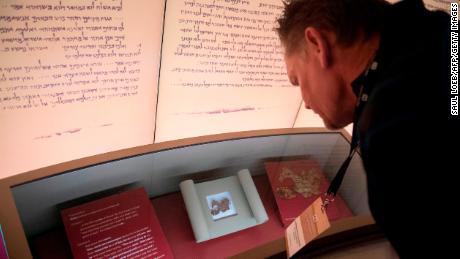 Visitors look at an exhibit about the Dead Sea scrolls at the Museum of the Bible in Washington, DC, on November 14, 2017. 