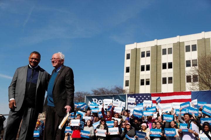 Civil rights activist Rev. Jesse Jackson stands on stage after endorsing presidential candidate Bernie Sanders at a rally in 