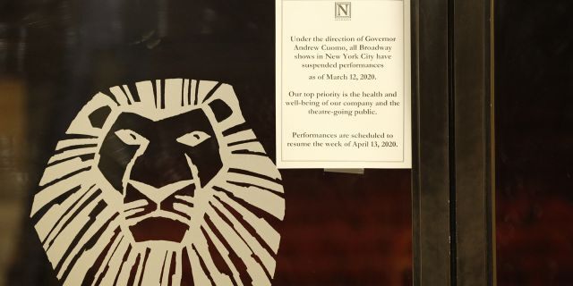 A sign announcing the suspension of all Broadway shows is posted on a door at the Minskoff Theatre, where "The Lion King" had been playing, Thursday, March 12, 2020, in New York. Gov. Andrew Cuomo banned gatherings of more than 500 people.