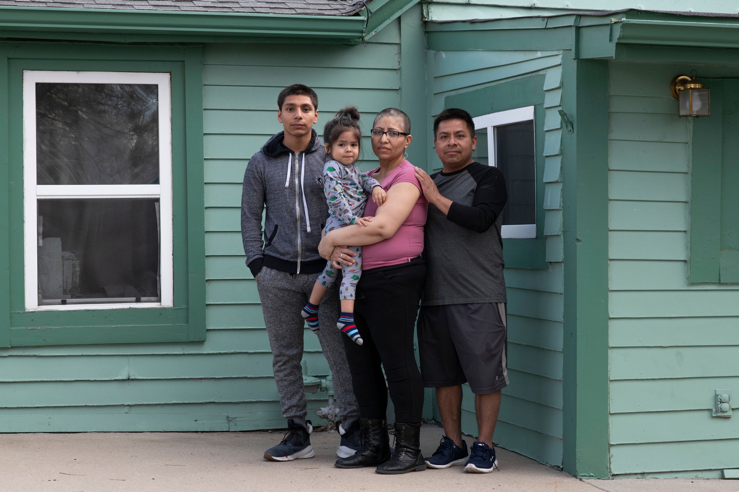 From left: Jorge Garcia, 15, stands with his mother, Ezzie Dominguez, who is holding her son Cristian Dominguez, 2, next to h