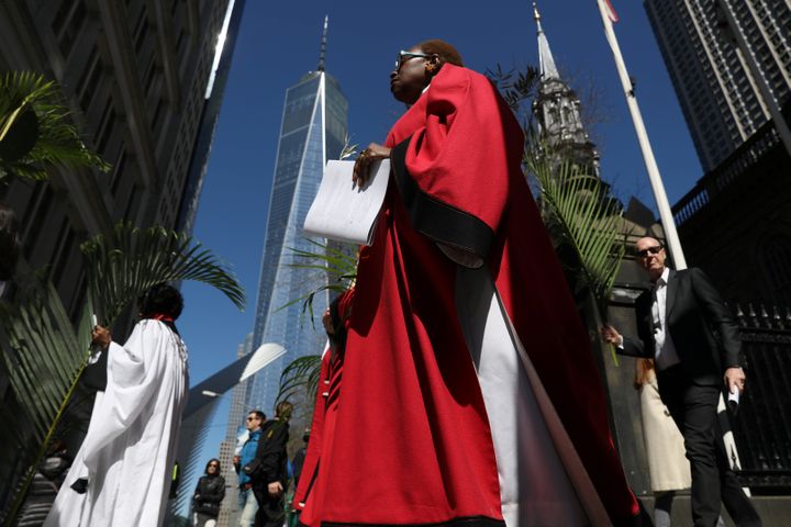 Worshippers walk with palms during a Palm Sunday procession from St. Paul's Chapel in Manhattan on April 9, 2017.