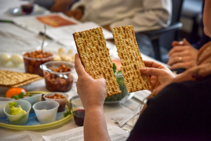 Rabbi Janet Ozur Bass breaks a piece of matzo at an Interfaith Passover seder on April 24, 2019, in Rockville, Maryland.