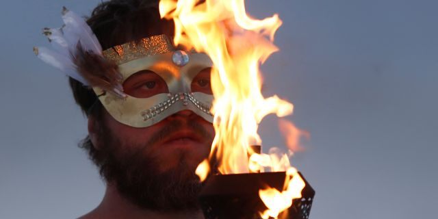A participant takes part in a fire ceremony as approximately 70,000 people from all over the world gathered for the annual Burning Man arts and music festival in the Black Rock Desert of Nevada in 2017. 
