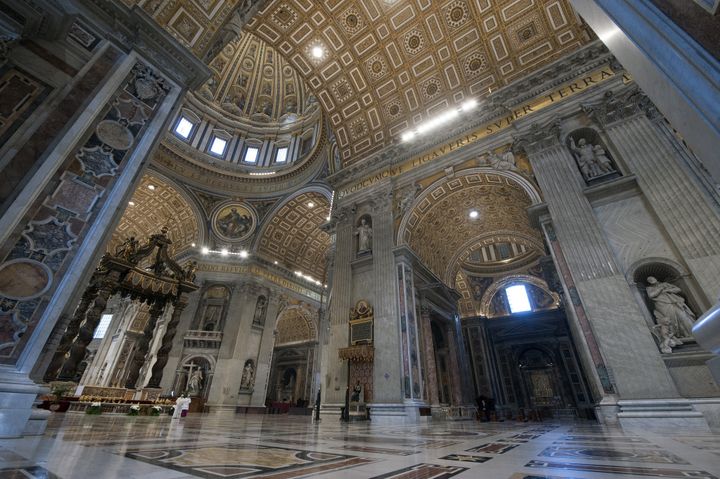 Pope Francis gives a blessing on Easter Sunday inside an empty Vatican Basilica.
