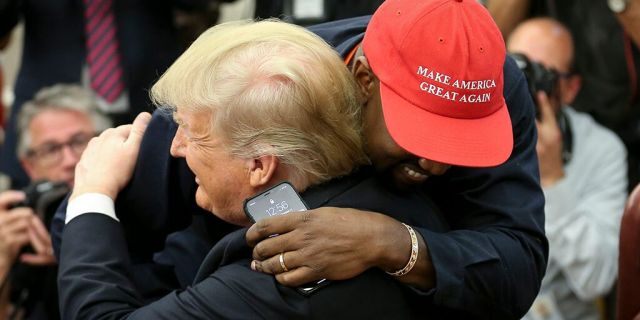 President Donald Trump hugs rapper Kanye West during a meeting in the Oval office of the White House on October 11, 2018 in Washington, DC.