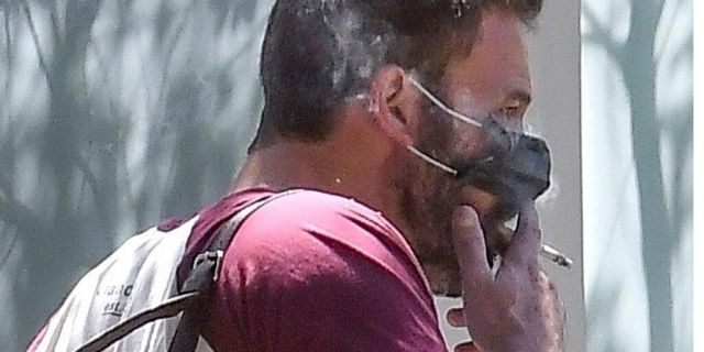 Ben Affleck was spotted smoking a cigarette with his protective mask partially off. 