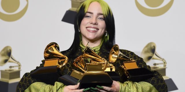 Billie Eilish poses in the press room with the awards for best album and best pop vocal album for 'We All Fall Asleep, Where Do We Go?', best song and record for 'Bad Guy' and best new artist at the 62nd annual Grammy Awards at the Staples Center on Sunday, Jan. 26, 2020, in Los Angeles, Calif. 