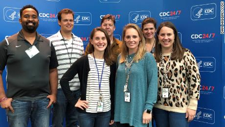 Alissa Eckert, center in green sweater, and  and Dan Higgins, back row in white polo shirt, created the coronavirus illustration for the CDC.