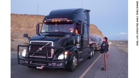 A Navajo Nation police officer gives a trucker information about the Nation&#39;s curfew.