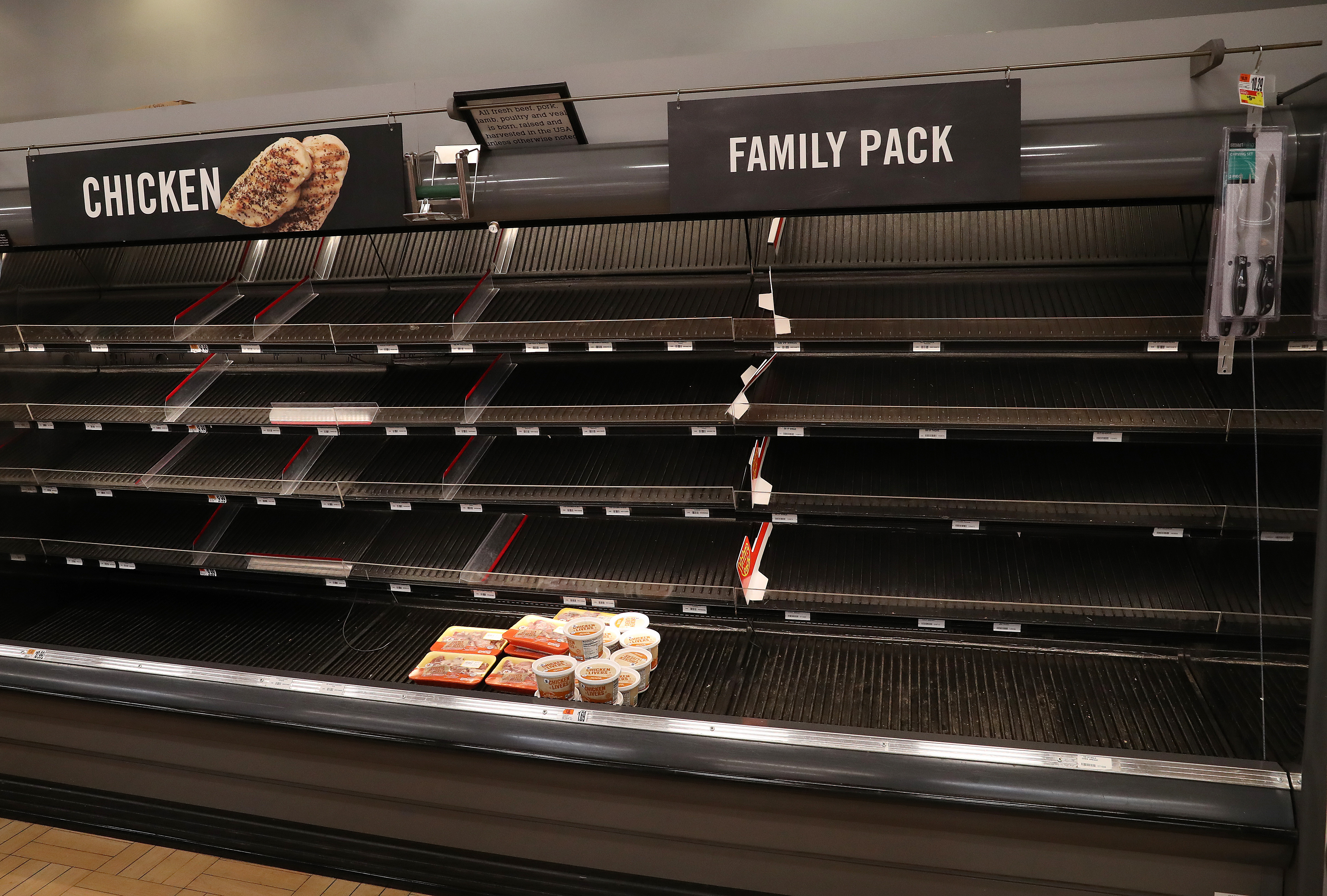 Shelves normally stocked with meat sit empty at a Giant grocery store in Dunkirk, Maryland, on March 13.