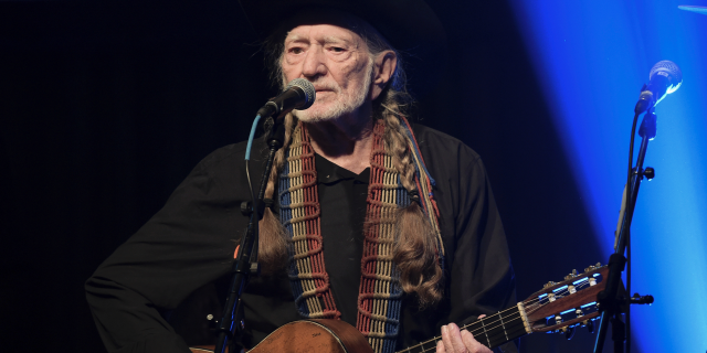 Willie Nelson is auctioning off signed face masks to raise money to help produce more. 