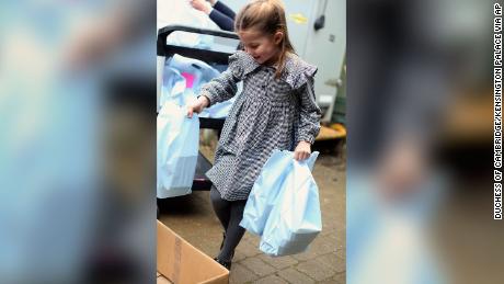 The young royal helped her family pack and deliver food.