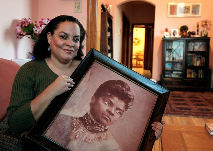 Michelle Duster, great-granddaughter of the civil rights pioneer, holds a portrait of Wells in her home in Chicago's South Si