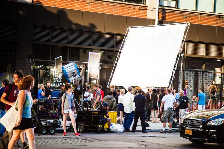 Camera operators and crew members setting up a shot on a street in Chelsea, New York.