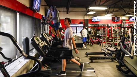 People use the treadmills and other equipment at Optimum Gym in Tampa on Monday, the first day it was back open for members.